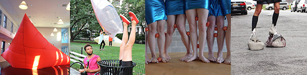 The first of four images is a close-up of a tomato-red inflated fabric sculpture in a tent-like shape, within an indoor art gallery with conical overhead lamps. The second image is a daytime scene in a park. A man sits on a bench, astonished to see a person upside down in a garbage can—their black shorts clad legs and red sneakers sticking up into the sky. In the background, two white translucent inflated sculptures are handled by two people. The third image is a closely cropped image of four people seen standing on a tan floor, barefoot, and wearing shimmering shiny blue skirts. The fourth image is an outdoor street scene, similarly cropped to show a person's skinny legs from the bottom of their skirt down. They wear black knee socks, with large clunky sculptural gray-colored objects on their feet.