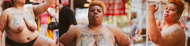 The first, closely-cropped photo, shows the torso of a Black woman, naked from the waist up, kneeling gracefully, their arm raised. The second photo is of the black-and-orange haired artist standing proudly, the words "Ain't I A Woman" written on their chest. The third image is a close-up of the same person, looking sideways, her left arm raised as if gently showing off her bicep.