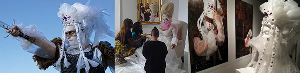 In the first of three photos, against swirls of blue, a strong figure stretches out their right arm, gripping a sword, with a fierce countenance as if they are commanding someone. They wear a black lacy dress and a poofy headdress made of tulle. Their outfit is wild, like a Samurai warrior's, but made of gauzy fabric, somehow simultaneously masculine, severe, and feminine. The second image shows three people kneeling in front of a regal woman seated in a white armchair. The seated woman faces the others and sports a white dress, pink collar, and a tall Marie Antoinette-like hairstyle, all of them reflected in a gilt-framed mirror on the back wall. The third photo shows the headdress from the first image, here on a wig stand atop a museum display case, in front of a photo of the same object in a different configuration.