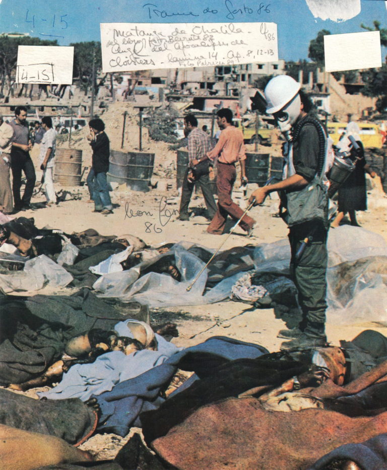 A color photograph of what seems to be the aftermath of a massacre. In the foreground appear bodies covered in blue, brown, black, and grey fabrics. A person stands among them holding a stick or implement of some kind, wearing a white face mask and white helmet. People are in the background walking by inattentive to the bodies. There are several white squares at the top of the image with handwritten notes within them.